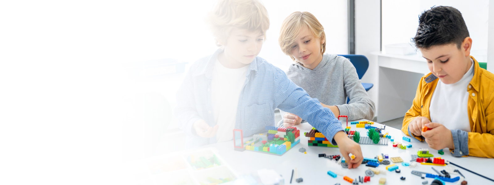 Children building with LEGO bricks representing the LEGO Group's purpose-driven team collaboration with Core Leadership Institute